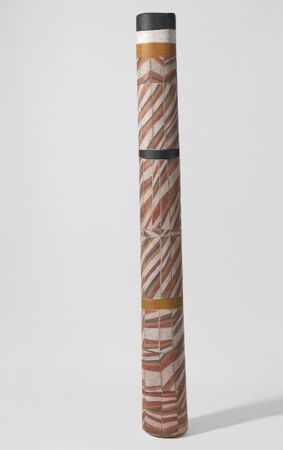Tall ochre, yellow, white and black pole with repeating stripe patterns
