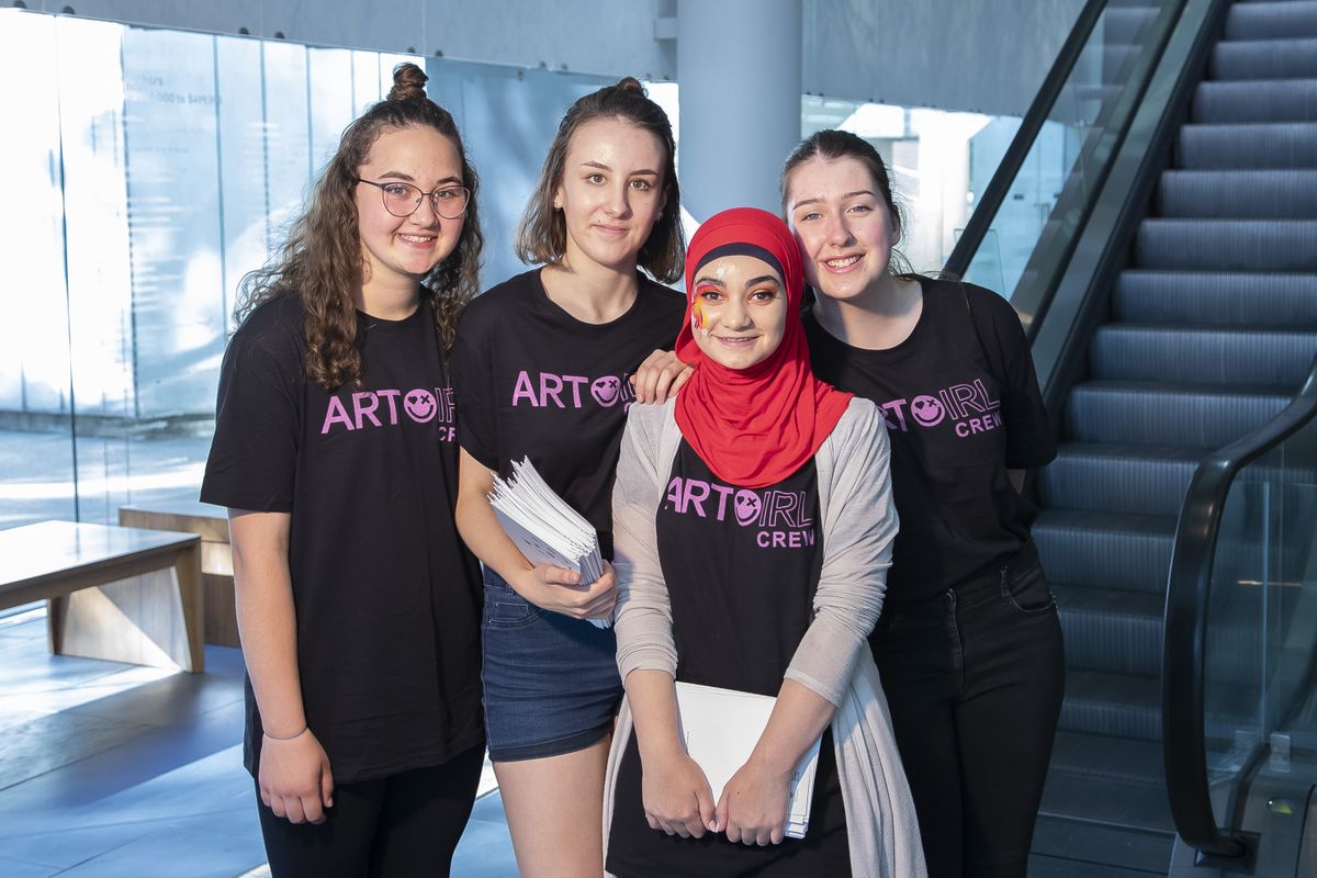 A group of four young people standing together