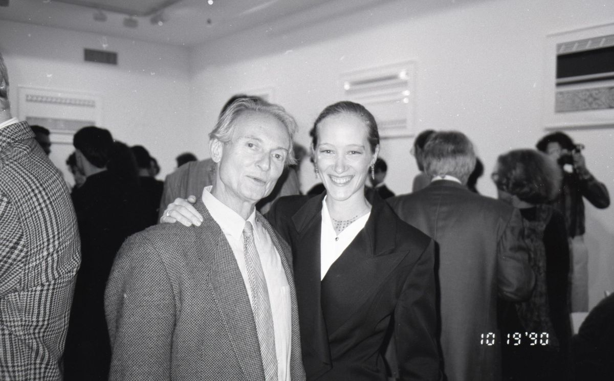 A black and white photograph of a man and woman standing next to each other