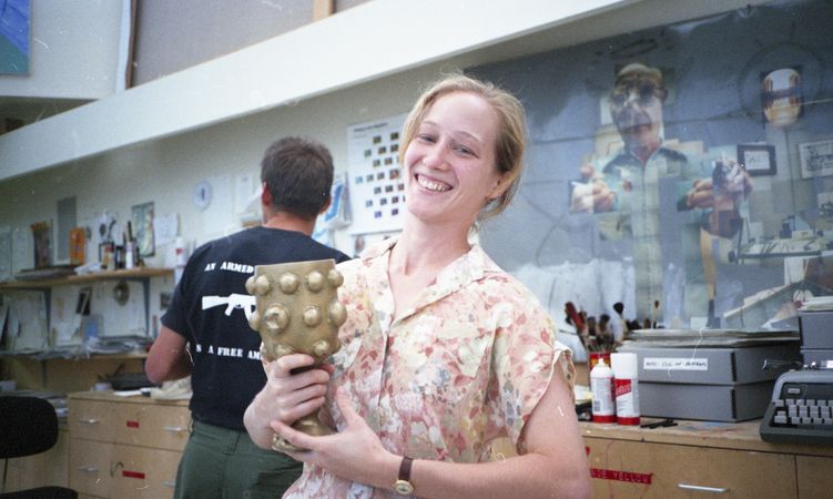 A woman holds a trophy