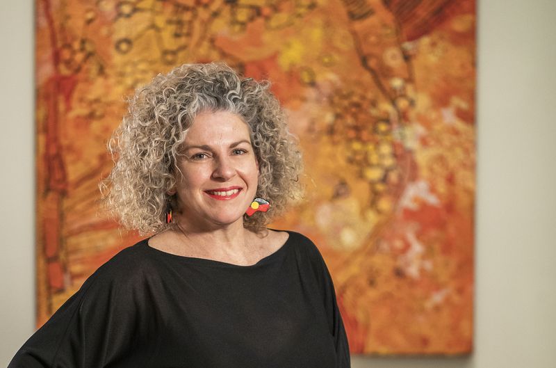 Portrait of a woman standing in front of artwork in an Art Gallery