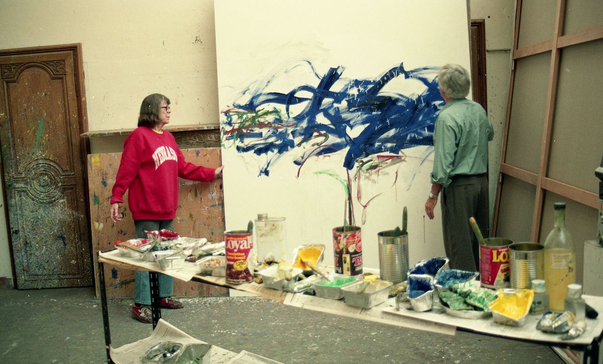 Photo of artist Joan Mitchell and Ken Tyler in studio with artwork