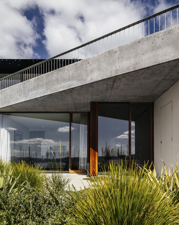 Photograph of domestic exterior with large concrete balcony above