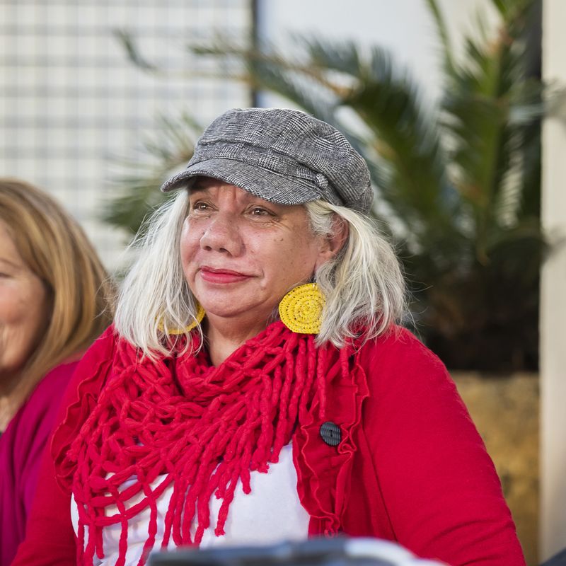 Three women are sitting at a table outside