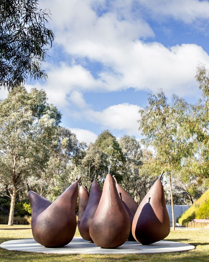 A group of seven brown metal pear sculptures