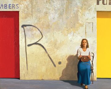 A woman, Germaine Greer, sits close to the front on a bent wood chair to the lower right of the painting. A wall graffitied with a large R rises directly behind her, with the edges of two brightly coloured doors visible on the left and the right edges.