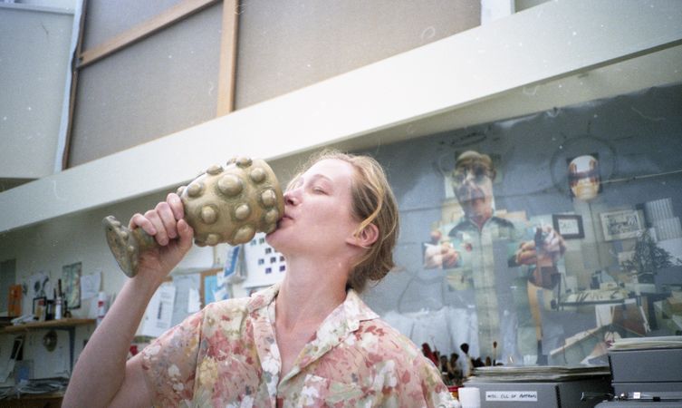 A photograph of a woman kissing a trophy