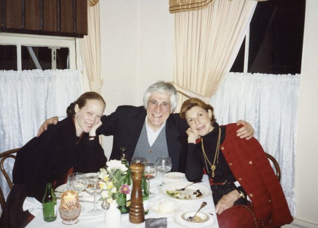 Three people sitting around a dinner table